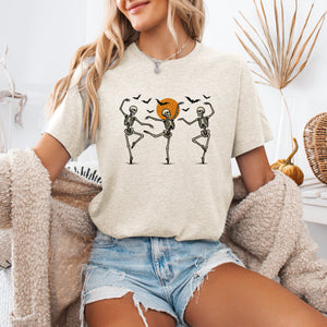 Skeleton Dancers Halloween Themed Spooky Dance Illustration With Playful Grinning Skulls Graphic Tee — view 1