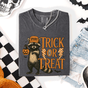Trick or Treat Raccoon Halloween Mischief With Skeletons Ghosts Cats And Pumpkins Comfort Colors Tee — view 1